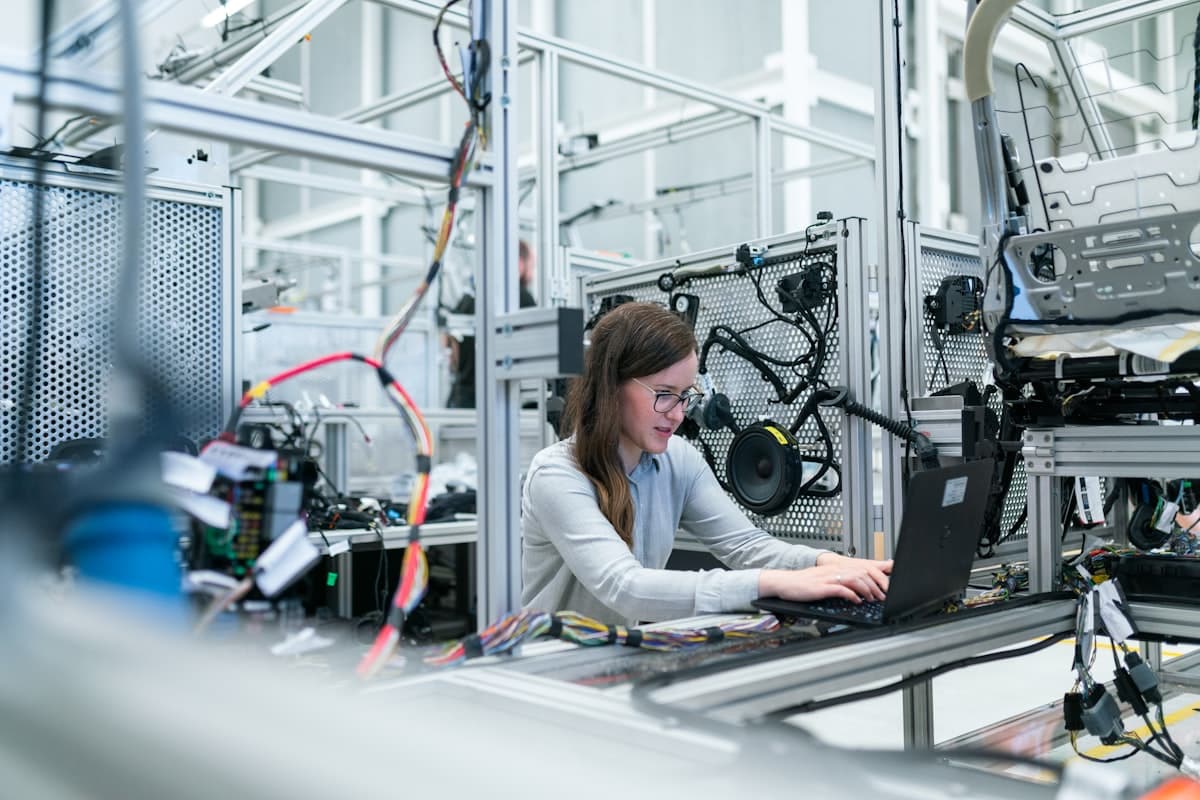 Technicians repairing computers and devices at a workbench