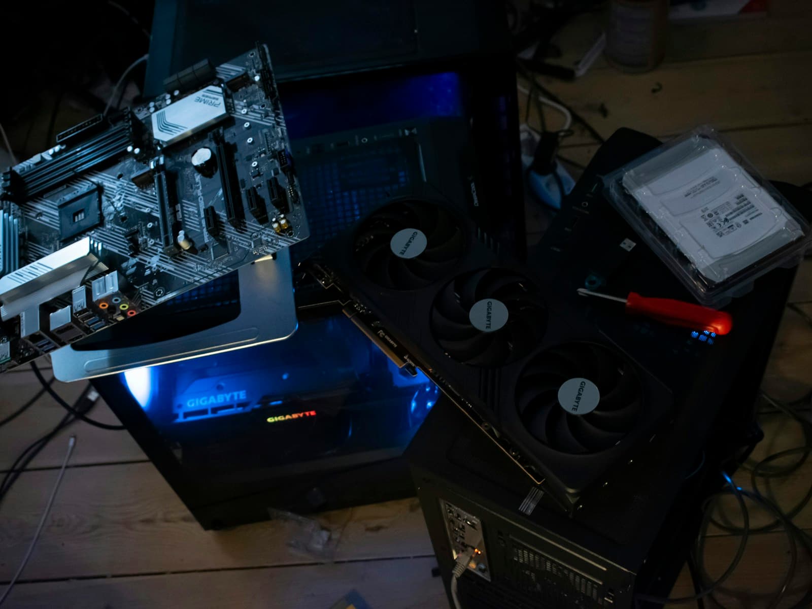 Computer case, motherboard, graphics card, and tools prepared for custom assembly